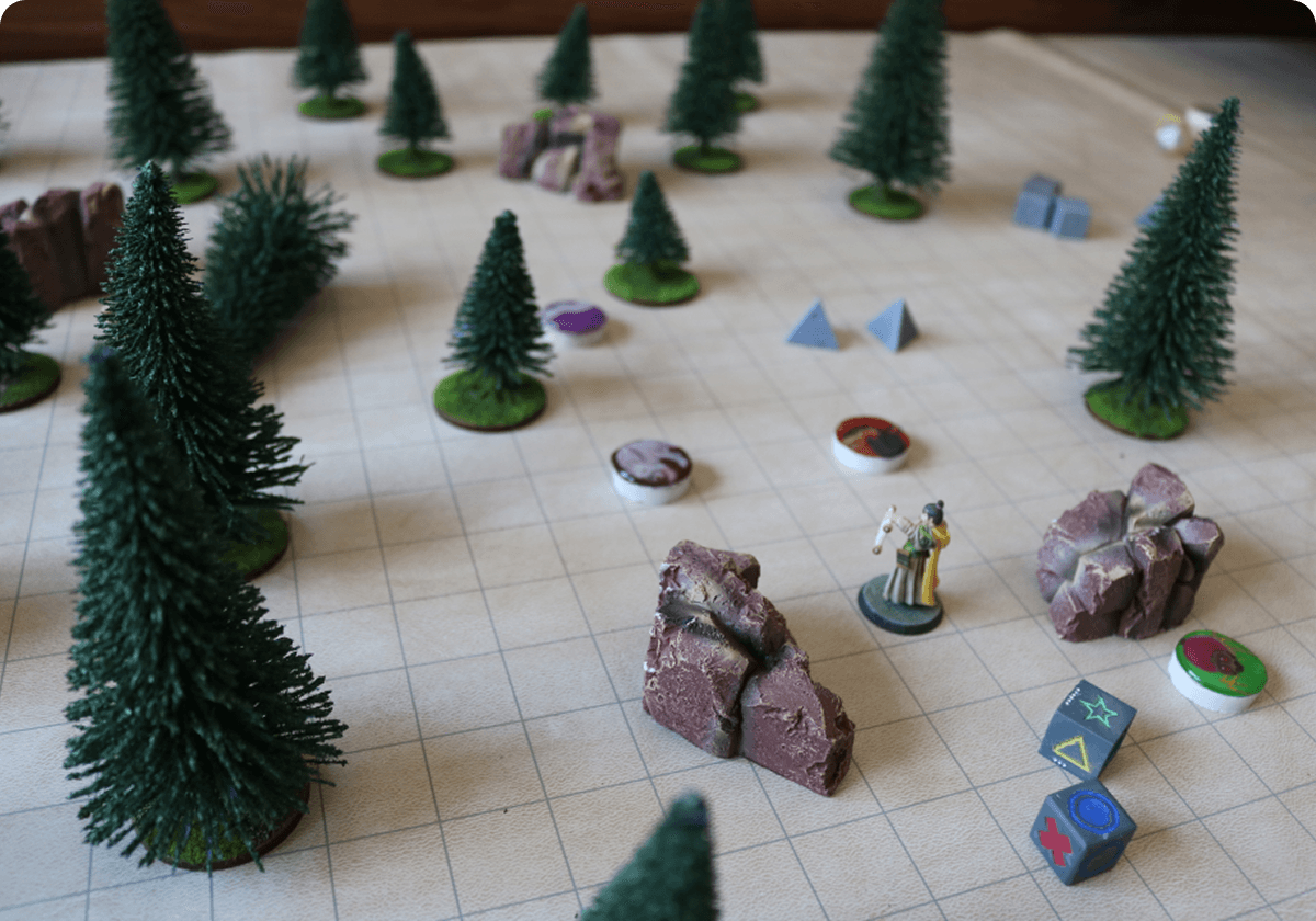 A tabletop gameplay prototype with miniatures, terrain and dice